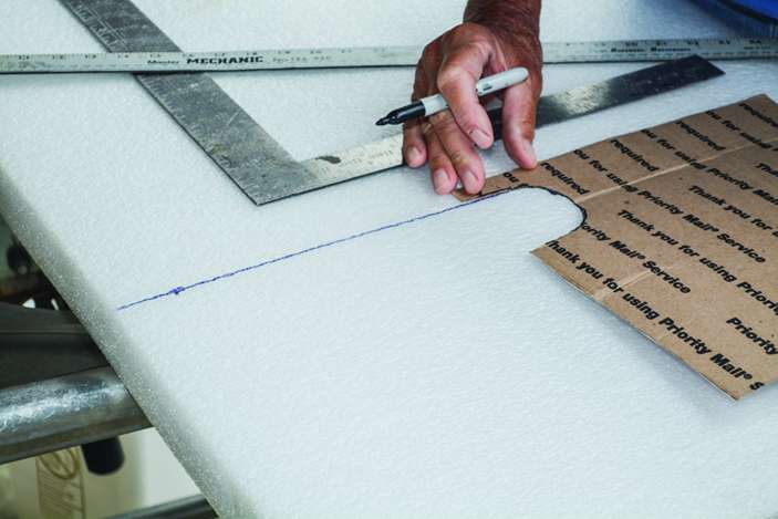 2. With a straight-edge, draw the pattern into the foam or carpet, making sure to leave some overhang where youâll slide your kayak on.