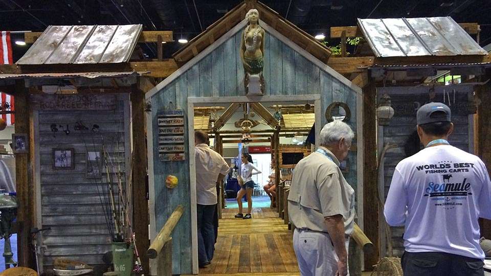 While the fly fishing interests are generally grouped near those pools, most of the freshwater and saltwater booths intermingled. Hereâs one booth with rustic appeal. It was set up by Seamule, which as the shirts says has the Worldâs Best Fishing Carts.