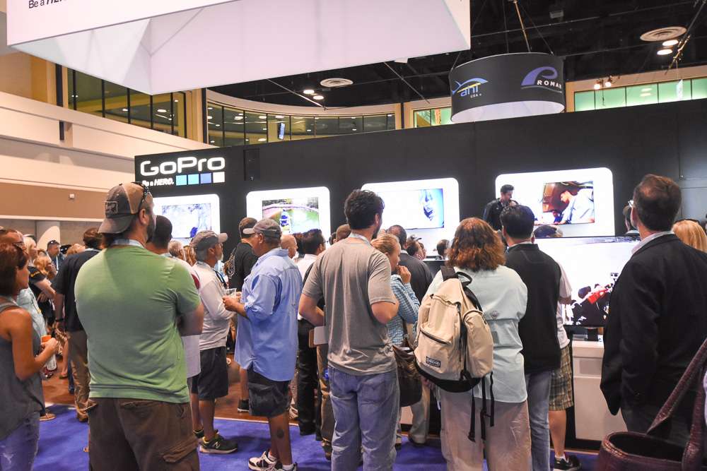 A crowd gathered for a presentation at the GoPro booth.