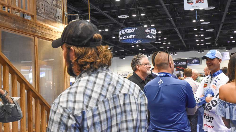 The 2015 Bassmaster Classic Champion Casey Ashley is in the crowded Costa booth greeting ICAST attendees.
