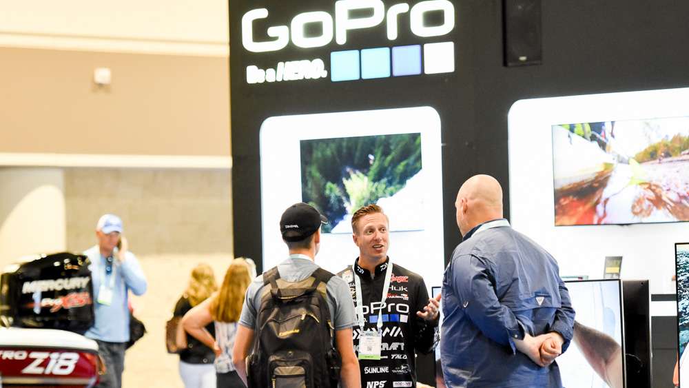 The GoPro booth is another popular spot. Brent Ehrler answers a question or two.
