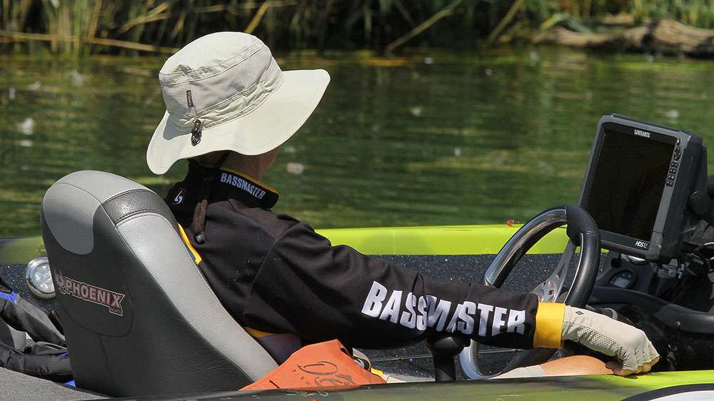 Who is the mysterious Bassmaster tournament official wearing the broad-brimmed hat, and sitting in the boat with Benton?  