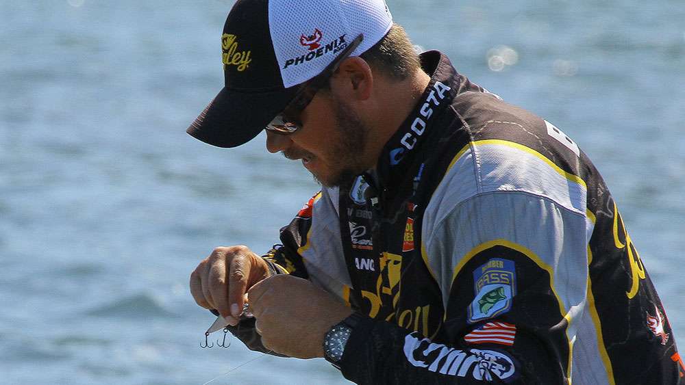 Benton retied his crankbait in hopes of catching another fish like it.  