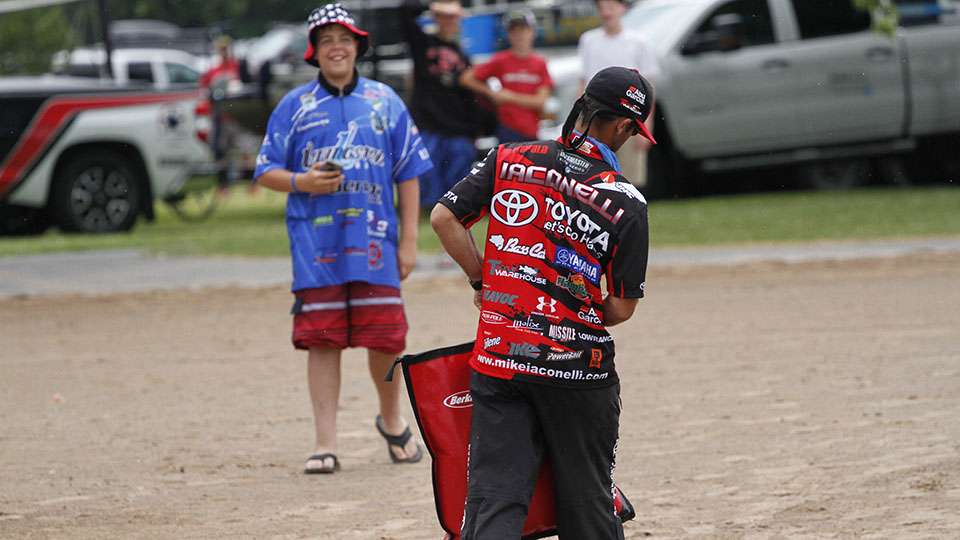 Mike Iaconelli walks to the tanks as an eager fan watches. 