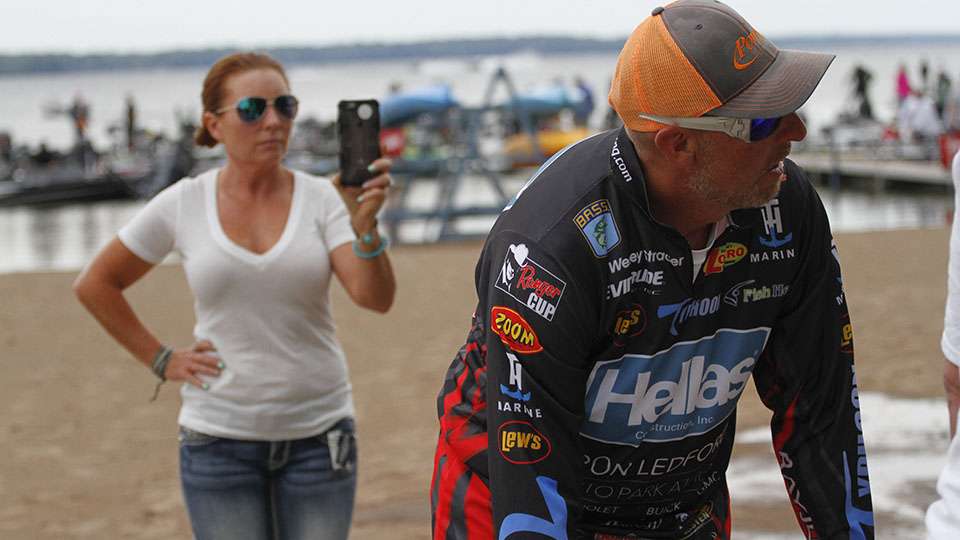 Meanwhile Wesley Strader waits at the tanks while his wife Stephanie shoots a Facebook Live video of him going through the Bassmaster weigh-in process.