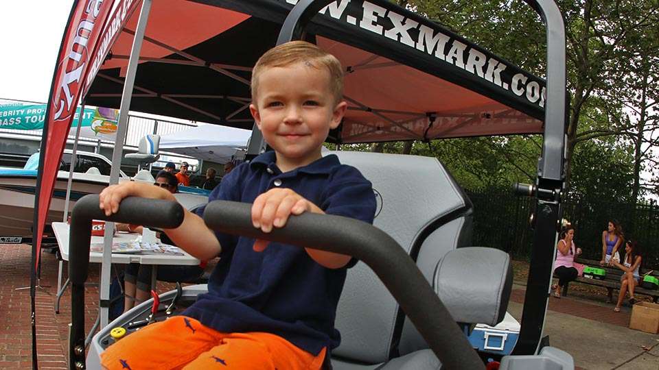Andrew Trotc, 3, is sitting pretty in an eXmark Mower, which was the second-place prize in the fishing competition.