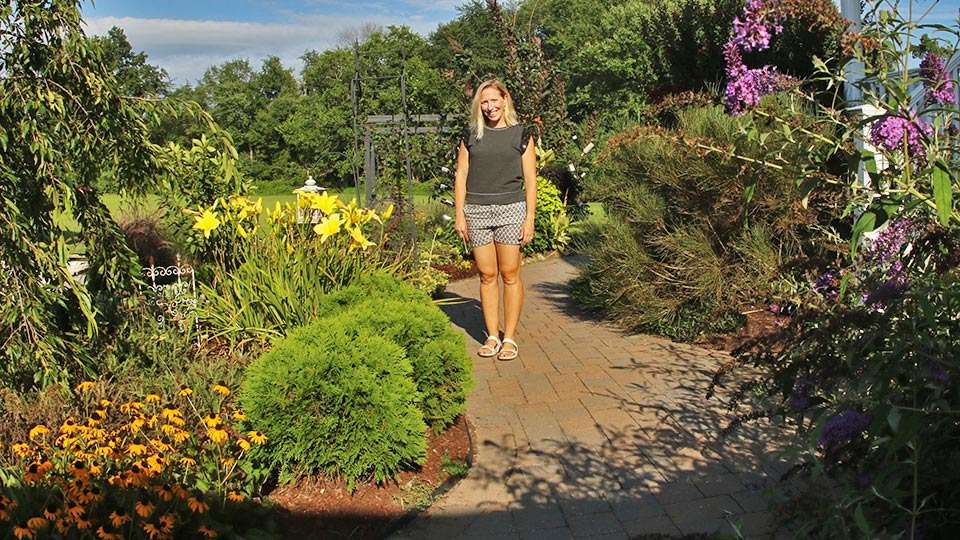 Standing in an assortment of ornamental trees, shrubs and flowers, Becky confesses that sheâs really taken to gardening.