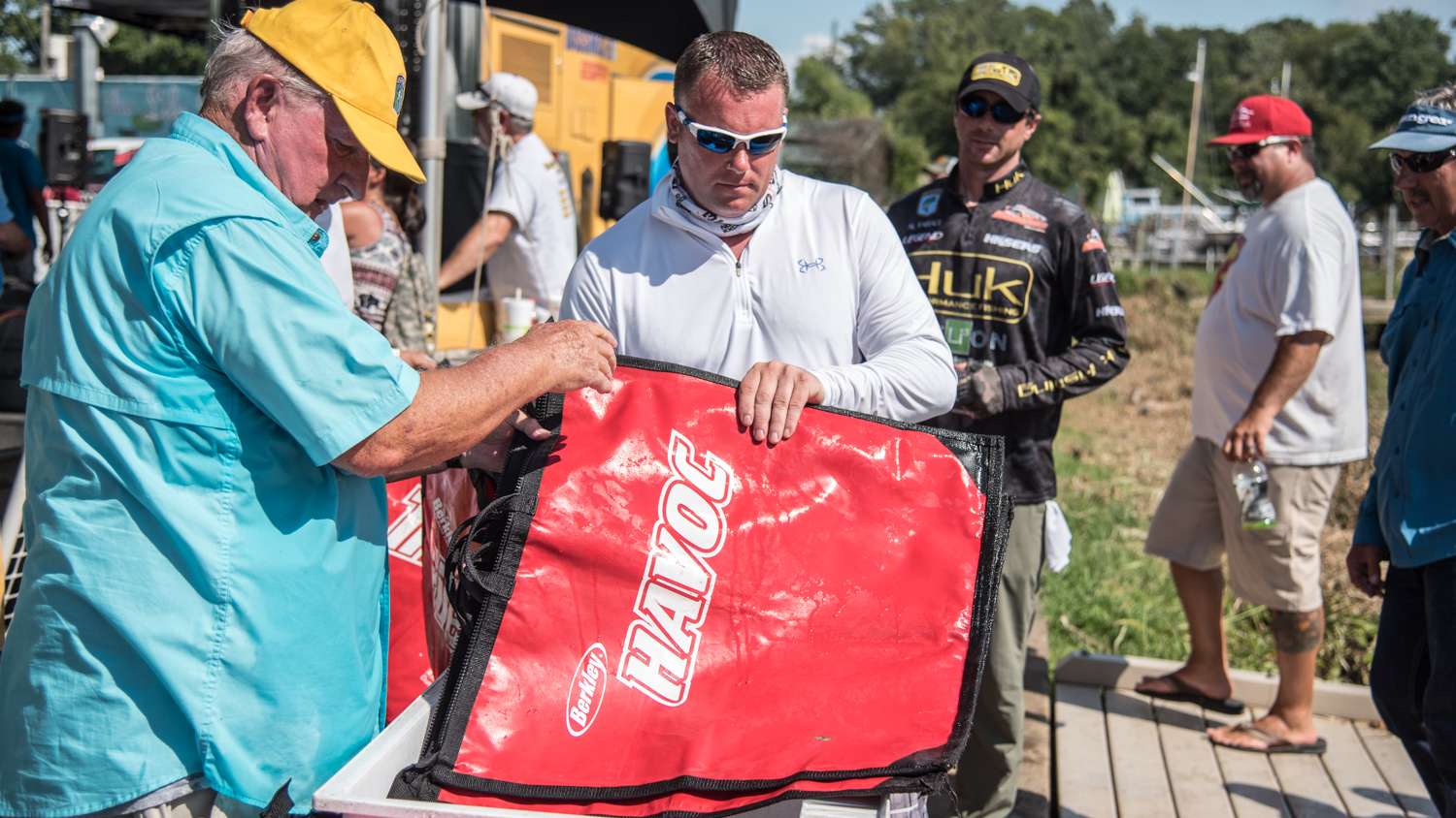 Anglers grab weigh-in bags. 