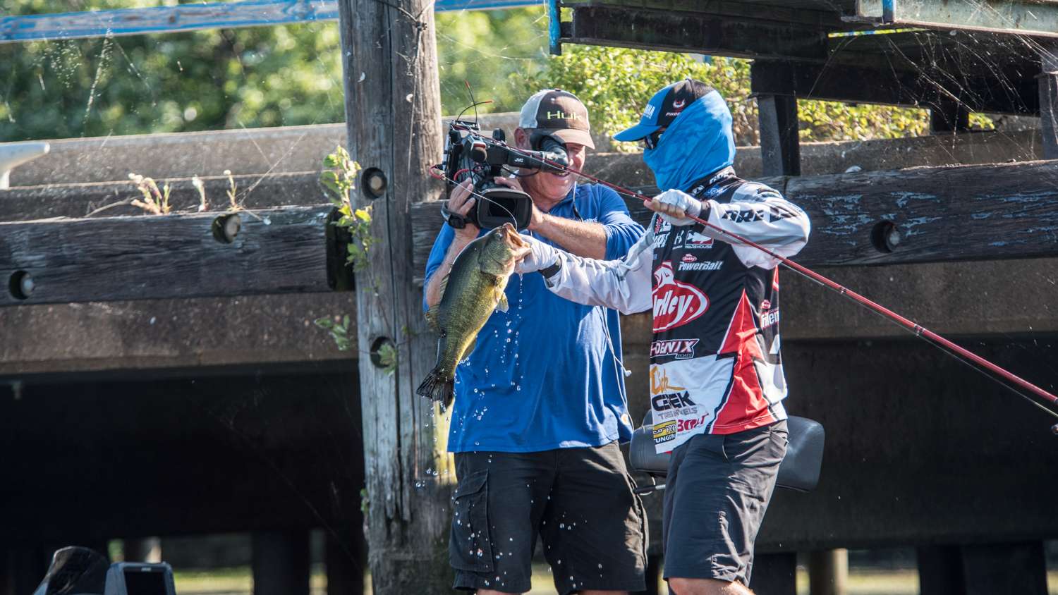 He holds the fish up for the camera as Bassmaster LIVE watches the excitement. 