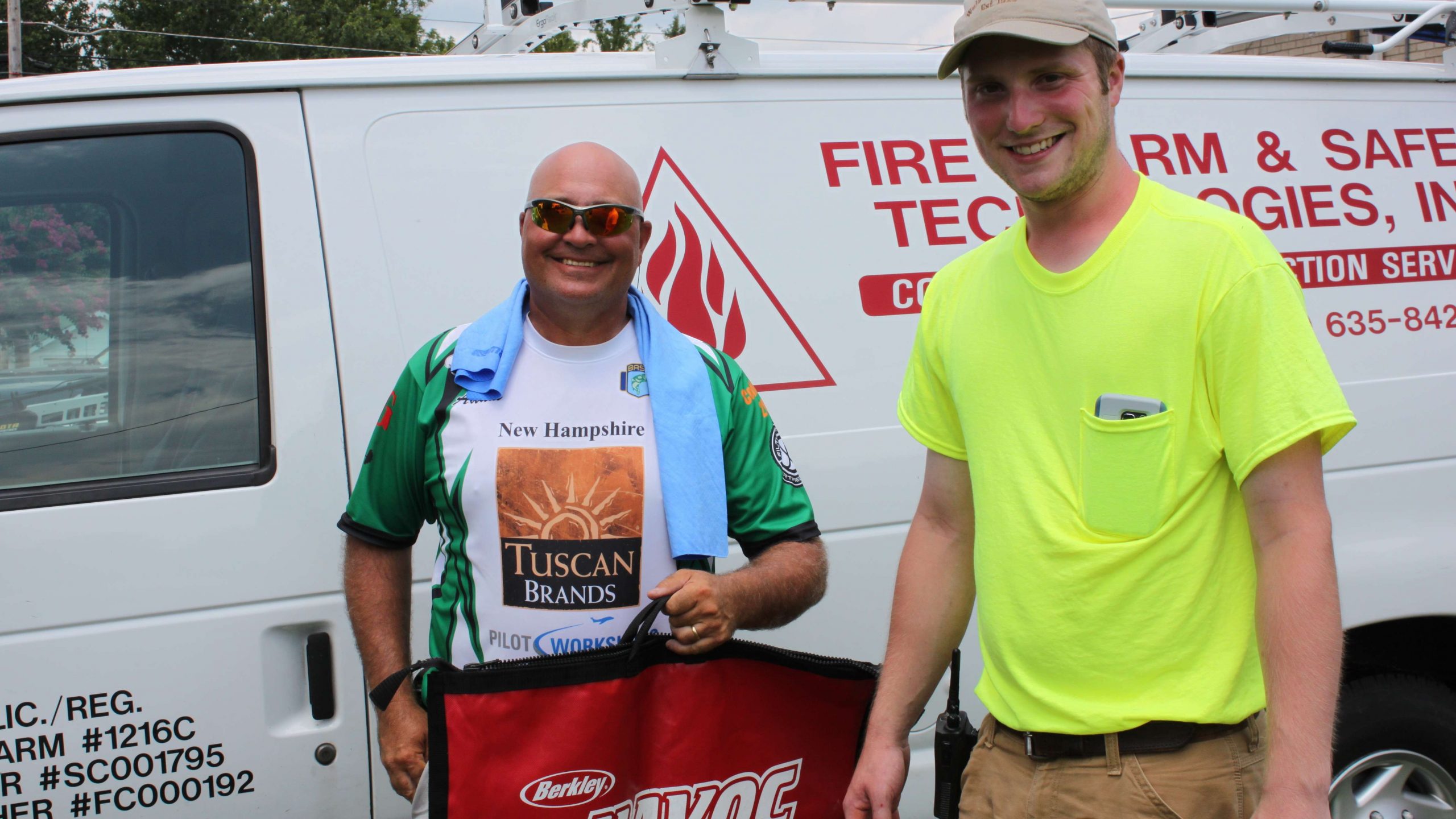 Kalem McMinn, right, of the Huntingdon Public Utilities Department, passed out weigh-in bags on Wednesday. Here he is with Team New Hampshire coach Adam Daniels.