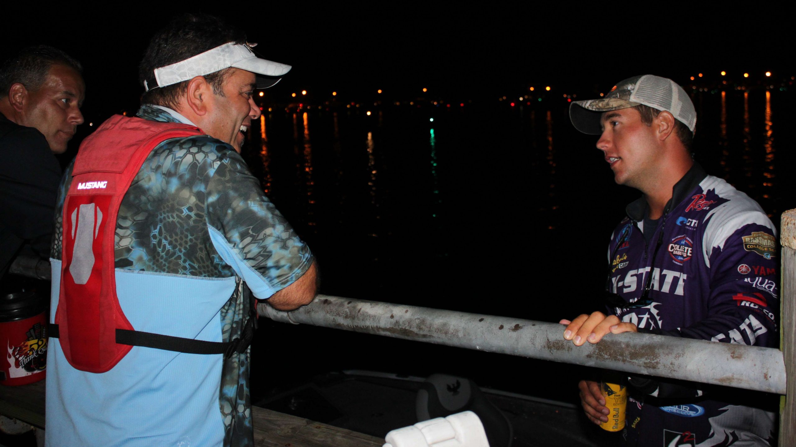 Kansas Stateâs Taylor Bivins chats with his father James, left, and his cameraman at the docks.