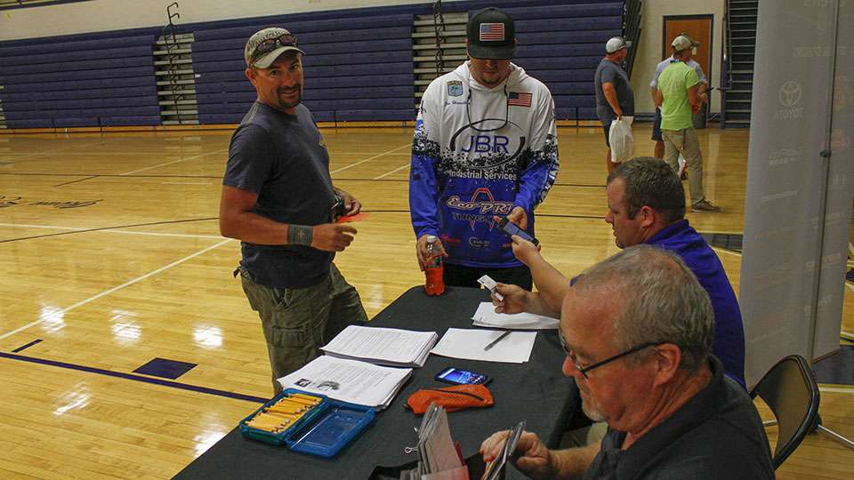 Joe Hamilton (right) gets his fishing license checked by B.A.S.S. officials.