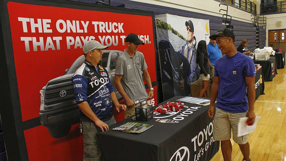 The Toyota booth is in attendance and their college representative, Trevor Lo, stops by to talk to the guys.