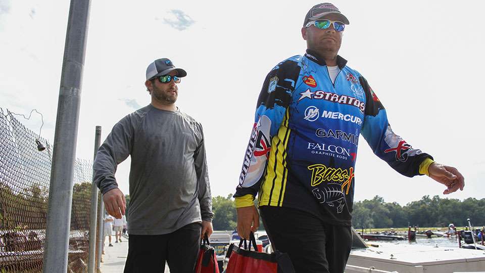 Justin McClelland heads to the stage with his co-angler not far behind.