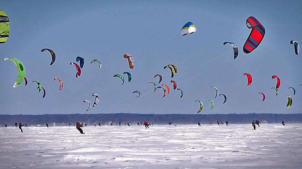 You know what Minnesotans do more than fishing? Find creative ways to get to their fishing spots. Just kidding. This scene is from the 10th Annual Lake Mille Lacs Kite Crossing in Garrison Bay in March of 2014 â¦ and those folks are racing to their ice fishing shanties. 