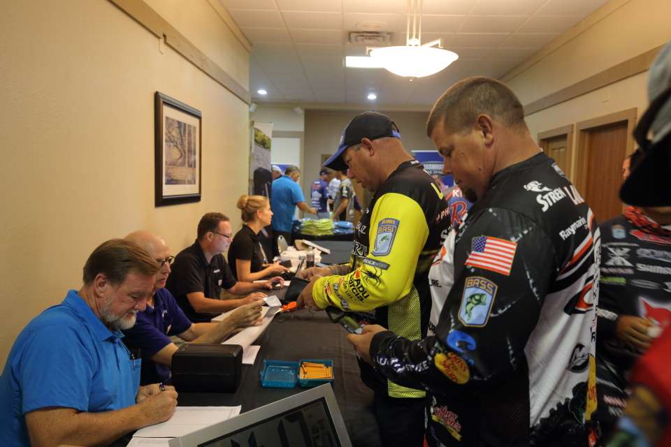 The Lane brothers, Bobby and Chris, show their fishing licenses to tournament officials.