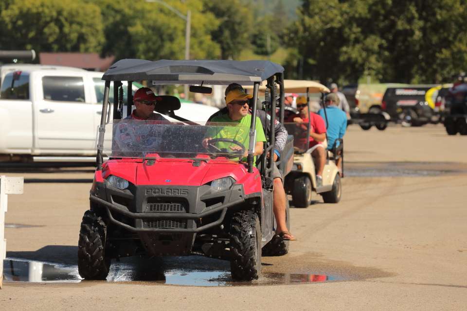 Anglers are transferred with golf carts from their boat to the weigh-in stage.