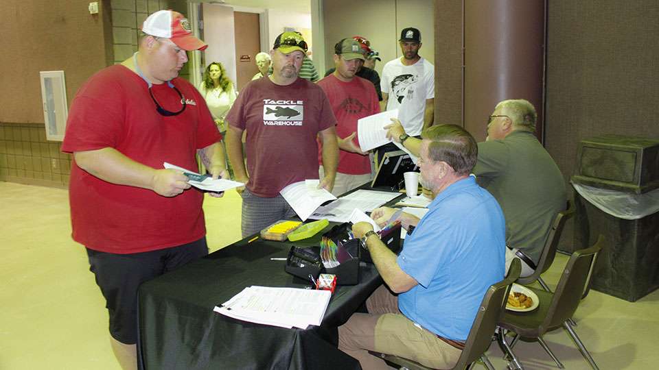 The B.A.S.S. Tournament officials begin checking fishing licenses as soon as anglers enter the building.