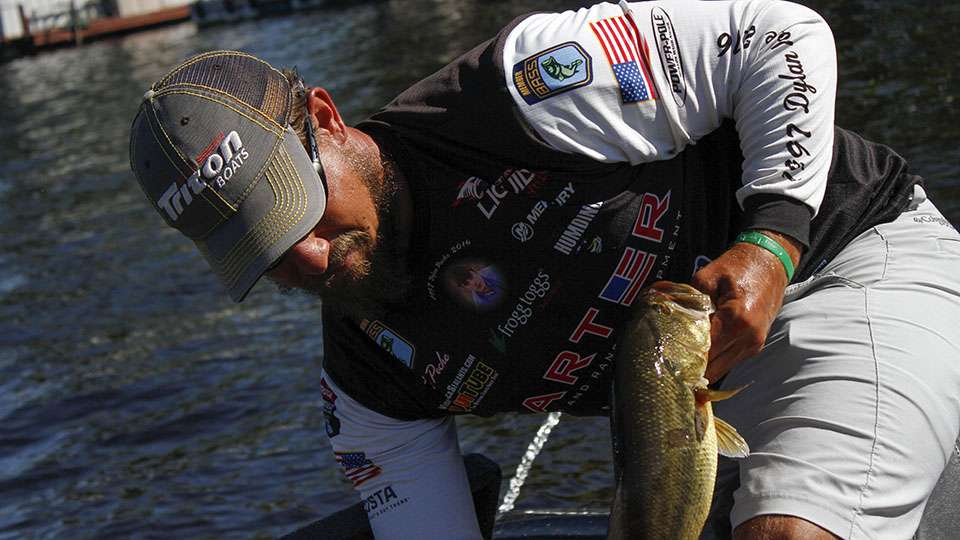 Keith Poche pulls a better fish from his livewell.