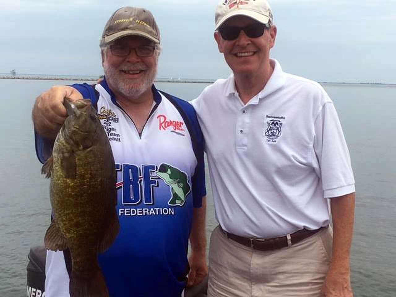 Boater Dave Reault shows a big Lake St. Clair smallmouth bass caught while fishing with Michigan State Representative Tim Kelly.