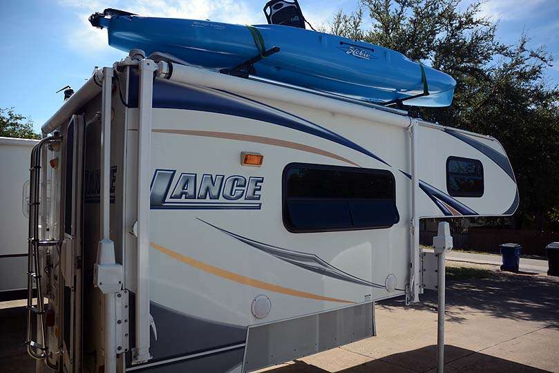 Parked outside is this Lance camper. Call it a mobile man cave. On top is a Hobie Mirage Outback for getaway trips along the way. It all rides over a half-ton pickup truck that pulls his BassCat bass boat. The rig racked up about 40,000 miles this year. 
