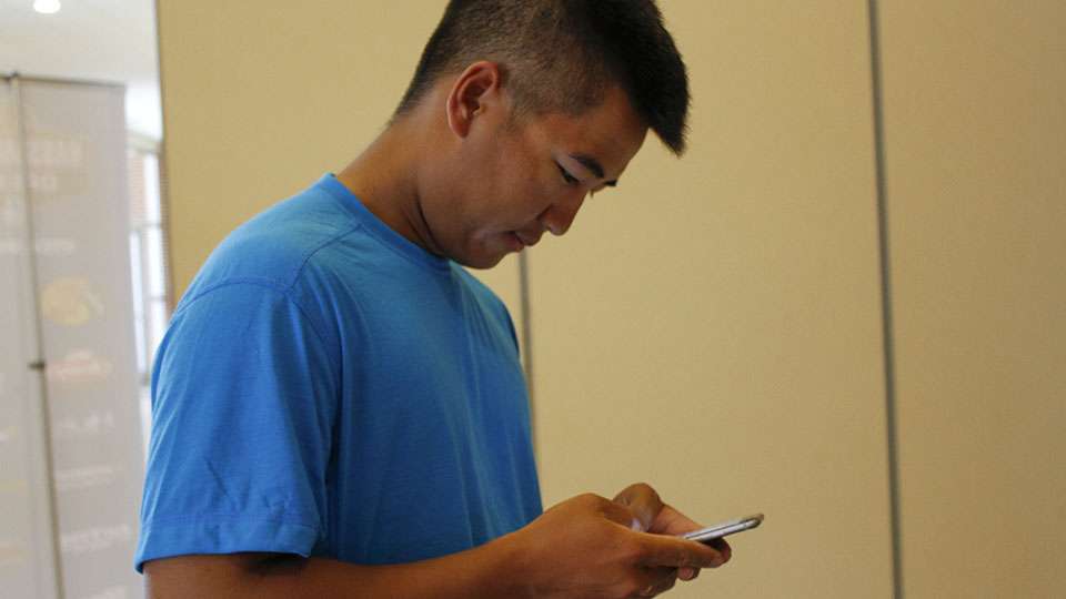 Trevor Lo pulls up his electronic fishing license to verify.