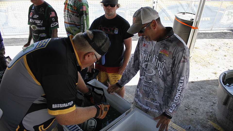 Luke Estel smiles as he gets his fish checked because he had a bounce back day and had 12 pounds.