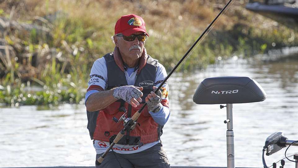 Tommy Martin puts his rods in the rod locker while he waits for his co-angler to back down his truck.