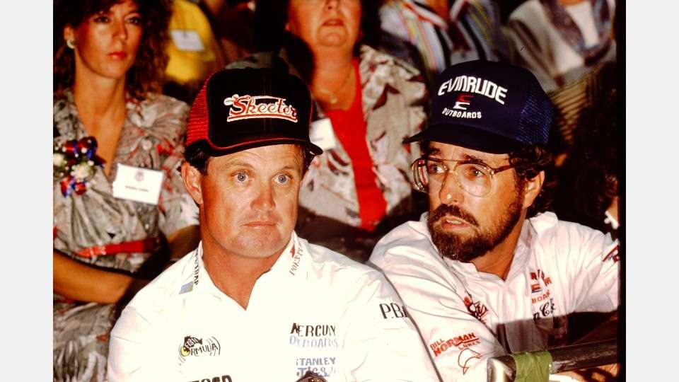 Rick Clunn and Ken Cook show some of the fancier signage on their tall front, adjustable, mesh-backed trucker caps in 1988.