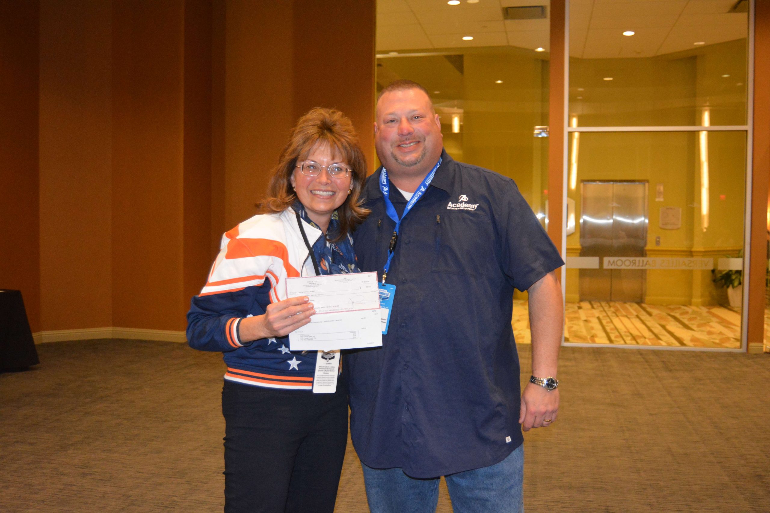 Audrey McKenney, president of the Colorado B.A.S.S. Nation, accepts a cash award on behalf of Colorado's Nate Caldwell, who finished in 12th place.