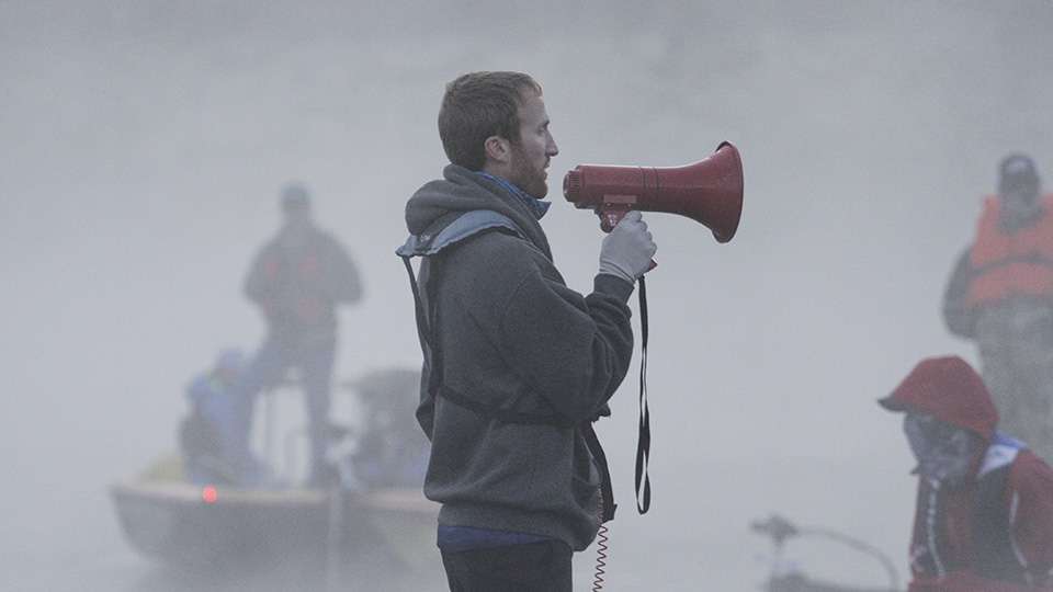 He used a megaphone to inform anglers there would be a fog delay to insure the safety of the field.