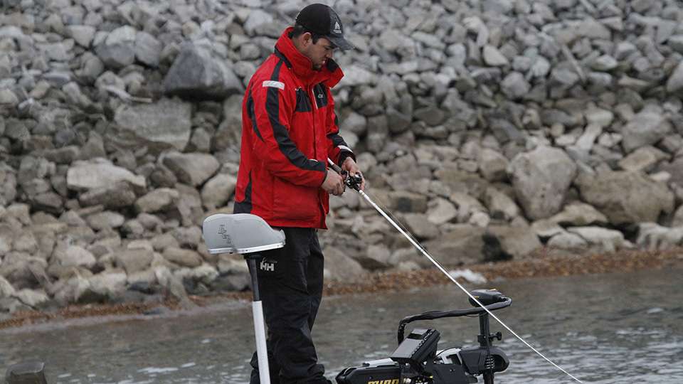 Baird checks his electronics as he fishes a crankbait. They had only caught some non-keeper bass earlier in the day.
