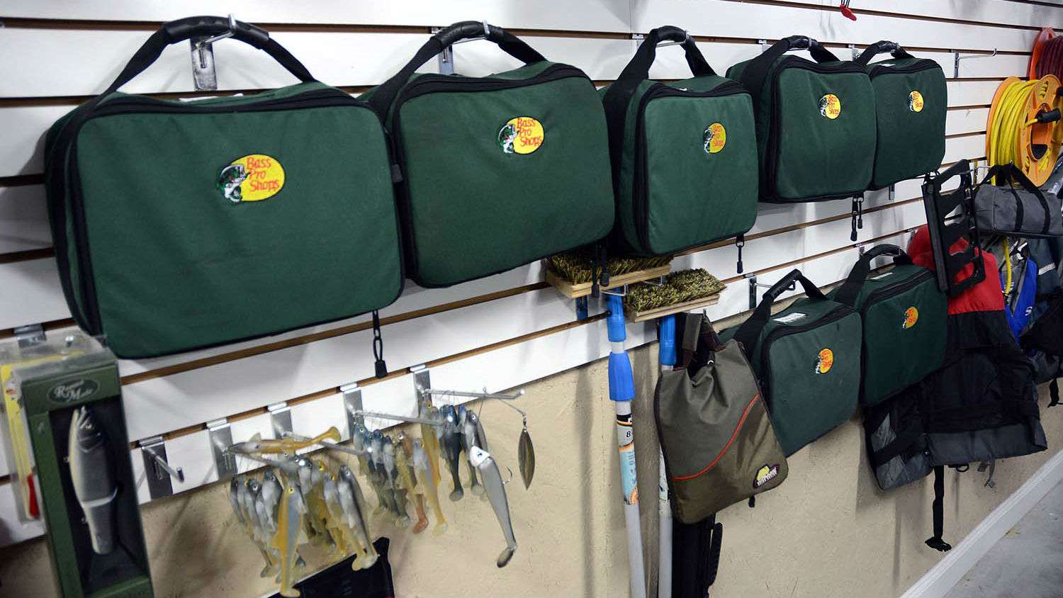 The shiny, clean surface indeed looks good and makes items lining the wall stand out. What is inside these Bass Pro Shops soft-sided storage bags is the serious eye candy to any serious Man Cave dweller. 