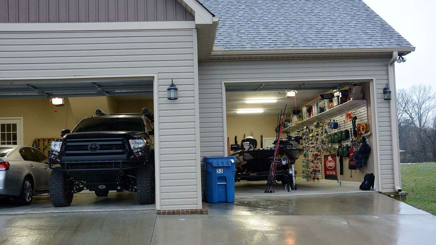 On one side is the garage door with an 8-foot clearance for the Toyota Tundra. Inside the opposite door with a 9-foot clearance is his Phoenix bass boat. Dimensions for the doors, and all the space inside, were part of the house plans.  