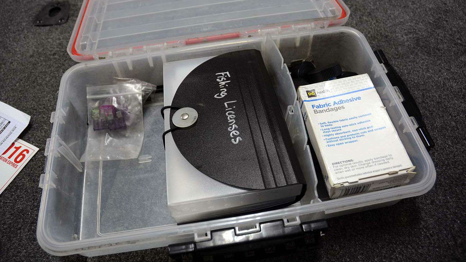 Organization comes down to the smallest items. The small pouch holds fishing licenses from around the country. The box contains boat insurance and state registration papers. 