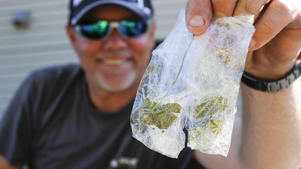He pulls out a clear baggy that contains two 4-leaf clovers that his family gave him. 