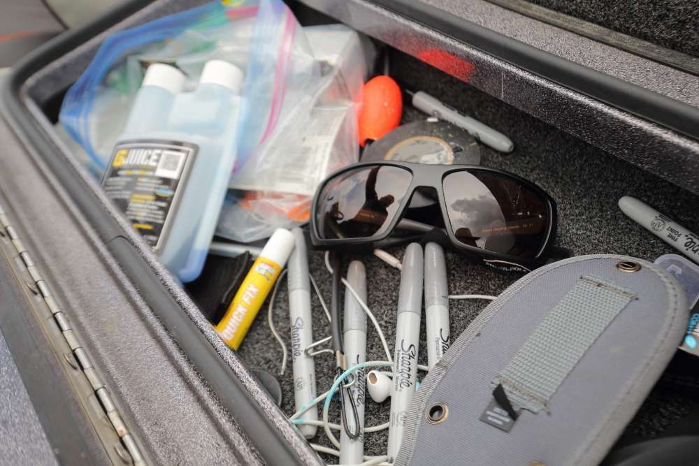 This shallow bin holds a number of small items including spare sunglasses, tape, Sharpie markers and more.