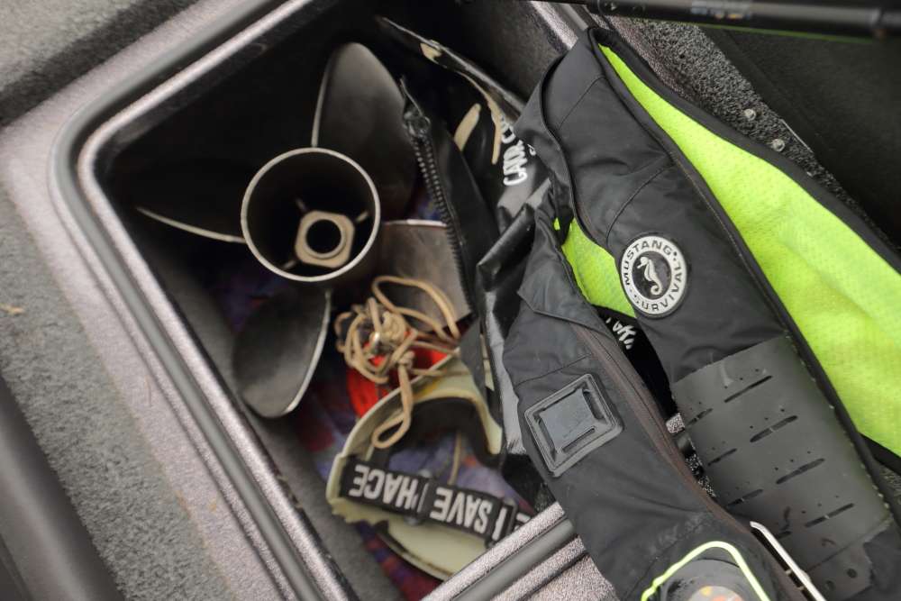 The storage compartment behind the driver's seat holds a spare prop, rope, an anchor, a bag for carrying fish and the life jacket that Lane wears. 