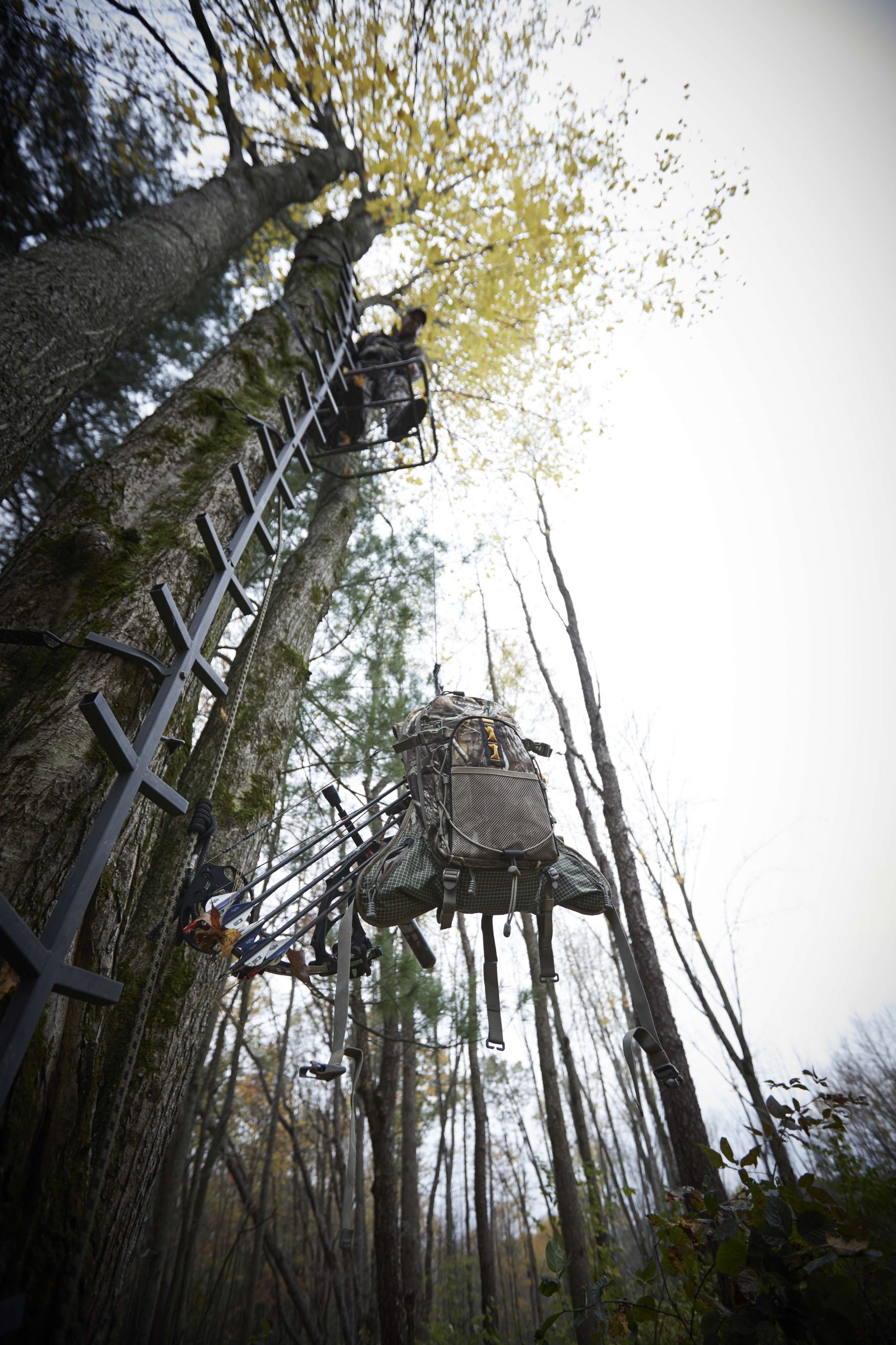 Once he's connected his safety harness, he hauls up his bow and Tenzing backpack holding the rest of his gear.