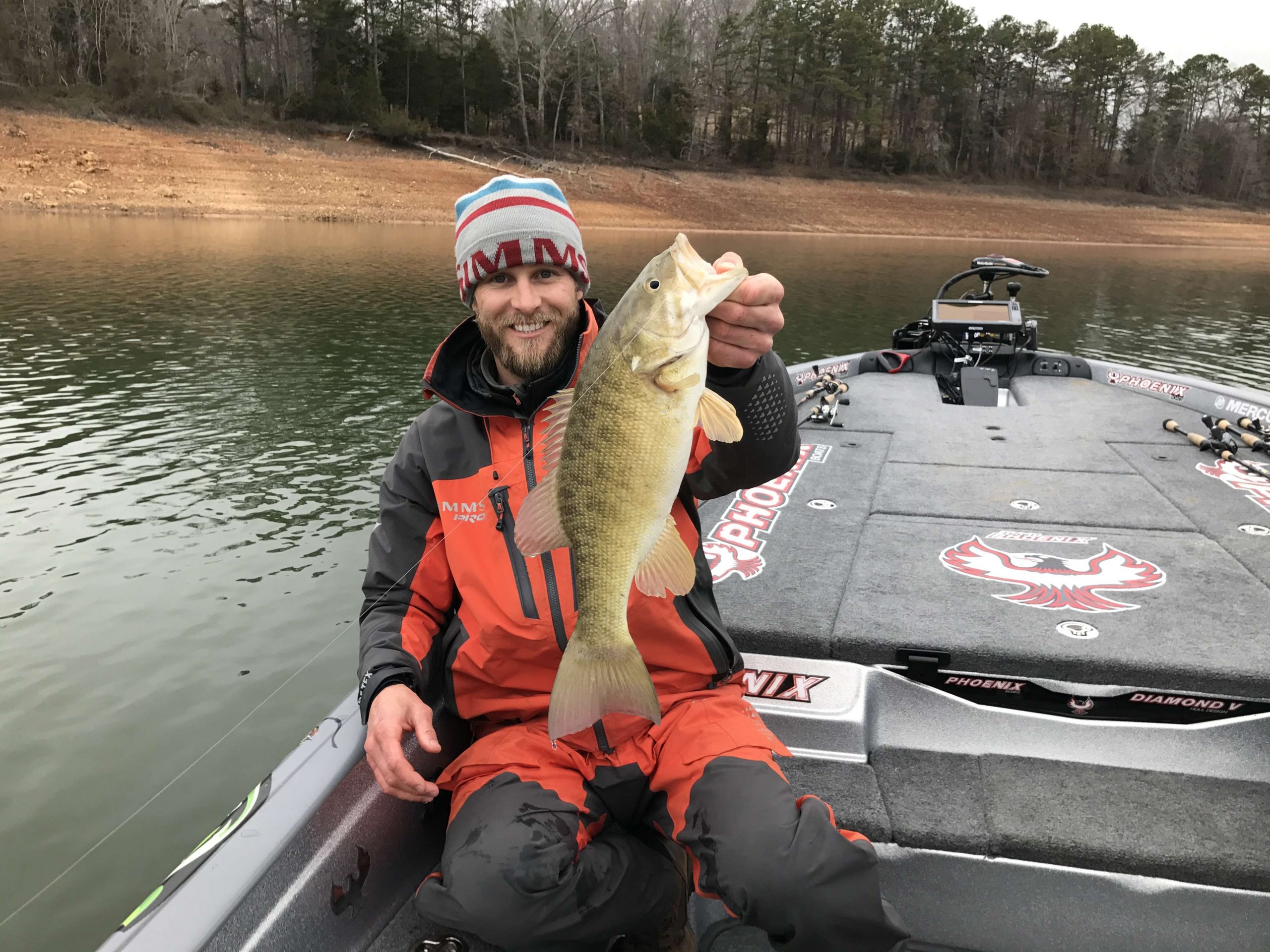 James Elam culls a small spot with a nice 3 pound smallmouth. Smallmouth are roaming, relating to the bait fish. Elam is putting on a clinic with his Lowrance sonars, finding fish and then getting them to come to his bait.