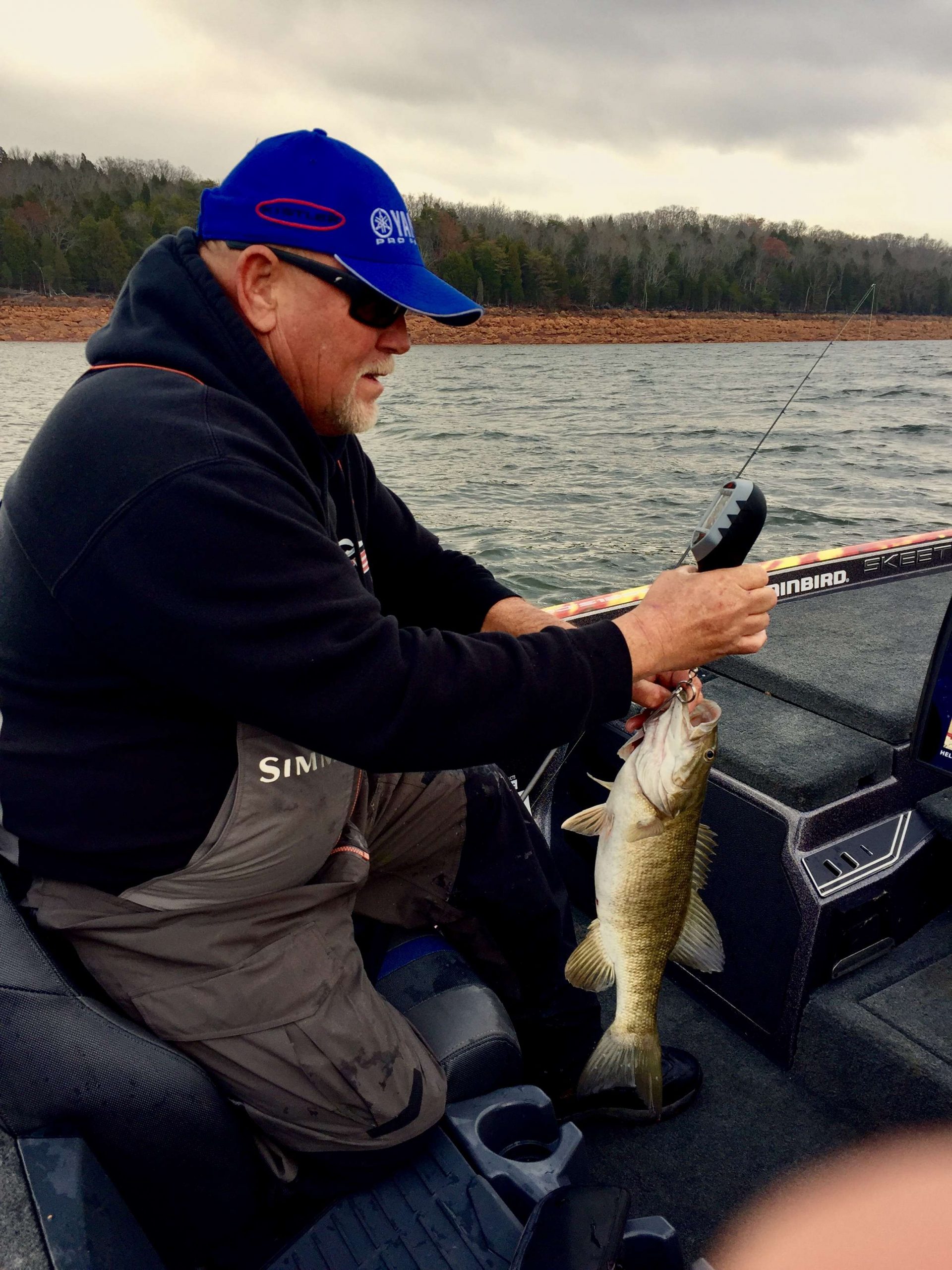 Matt Herren is in deep concentration . The mood has lightened but he is still concentrating hard to upgrade the weight to his five-fish limit.