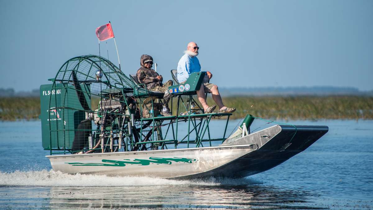 A fan boat roars by, possibly Santa Claus on a February vacation to Lake Okeechobee?!
