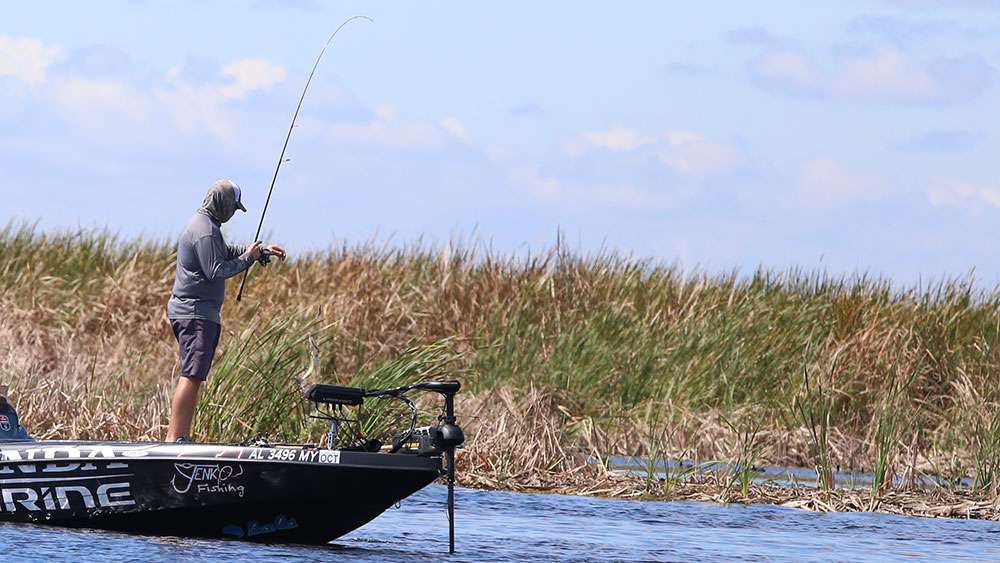 He flips the small bass aboard his rig. 