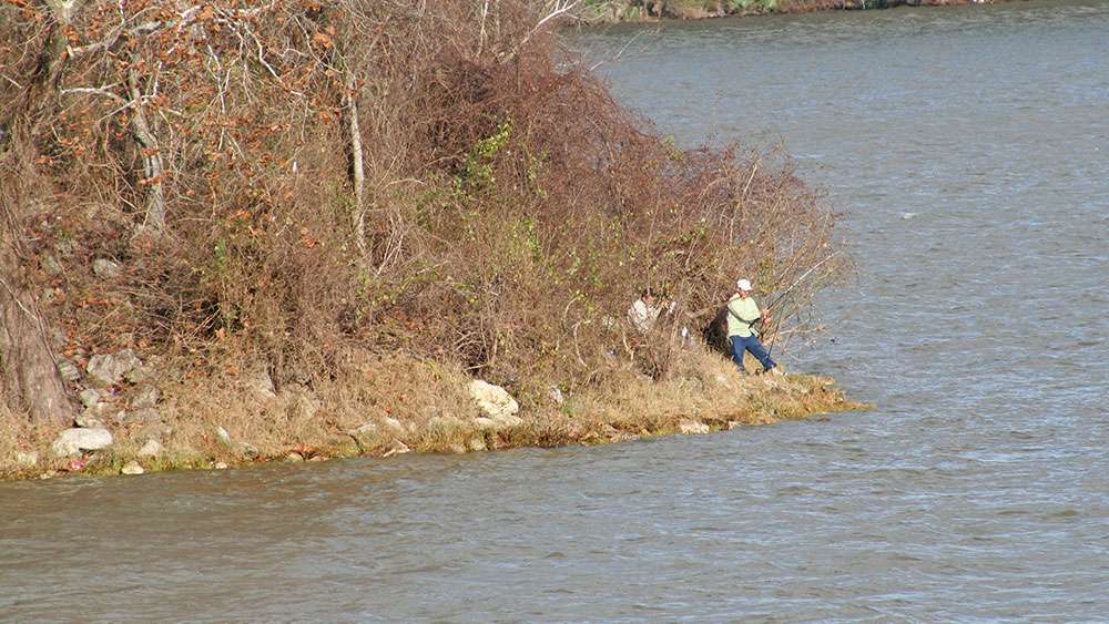 Numerous anglers fish off the riprap from the shore around the bridges that cross the lake.
