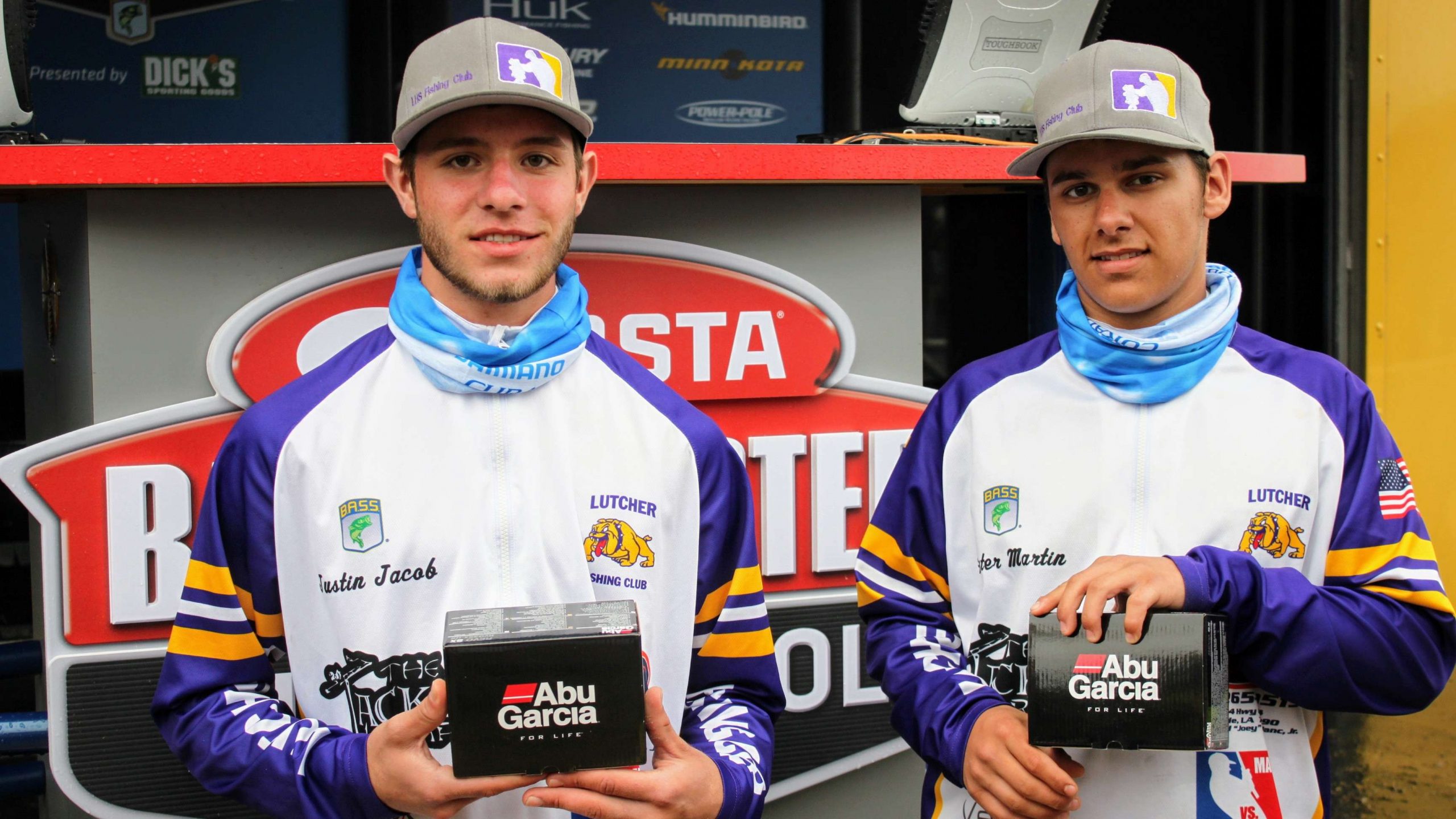 Big Bass Award winners Justin Jacob and Hunter Martin display the
  reels they won for the 8-11 lunker caught Saturday.
