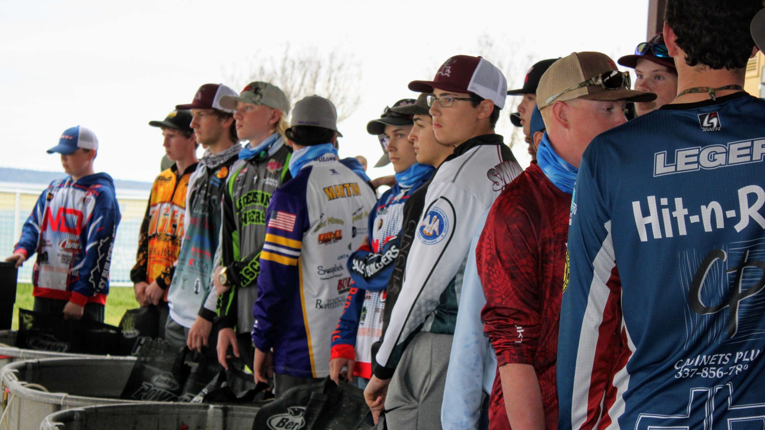 A line of young anglers begins to form at the tanks as the
  Bassmaster High School Central Open is about to begin.
