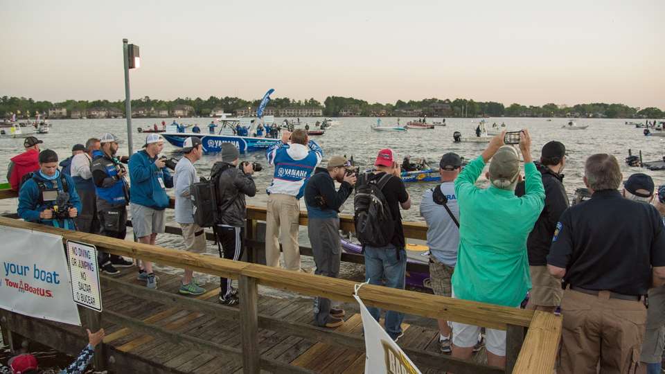 Members of the media gather at the launch point for takeoff.