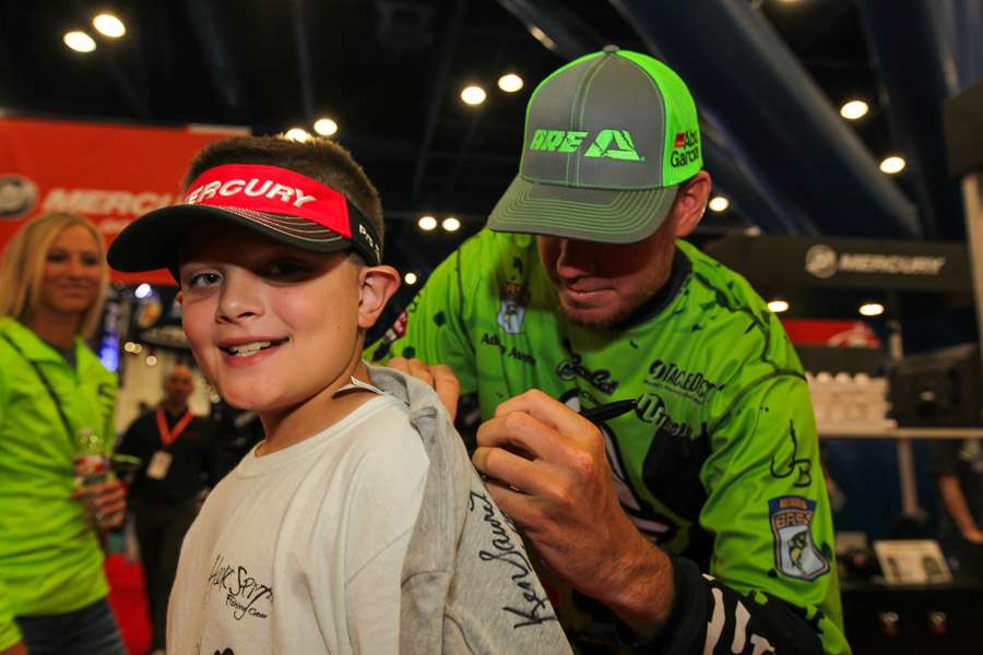 Adrian Avena signs the shirt on this young anglerâs back!