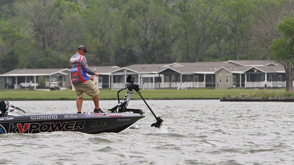 Local favorite Keith Combs fights the wind as he lifts his trolling motor to go in search of more fish.