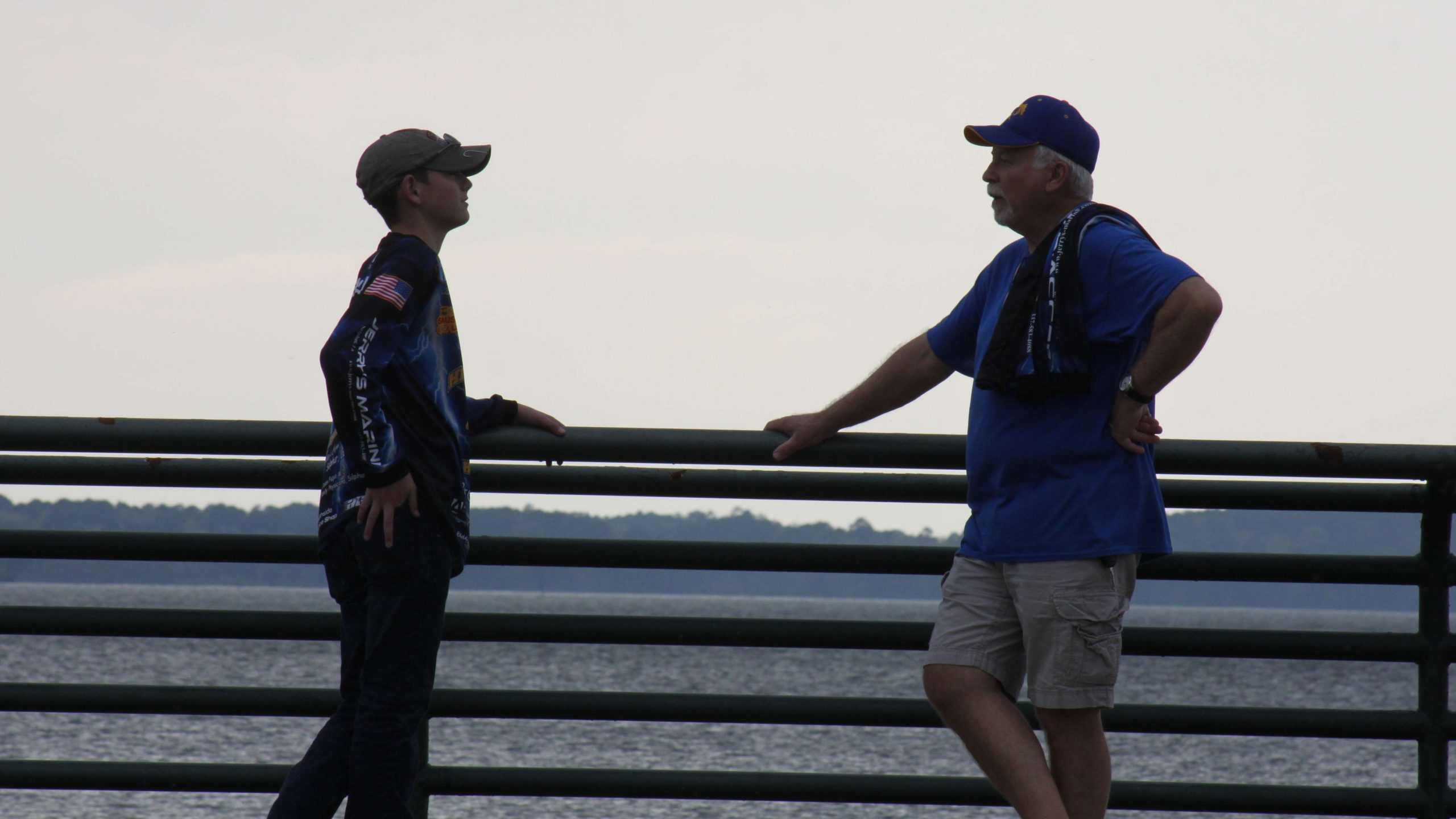 A young Sulphur High angler gets some advice from his boat
captain as the sun sets on Toledo Bend.